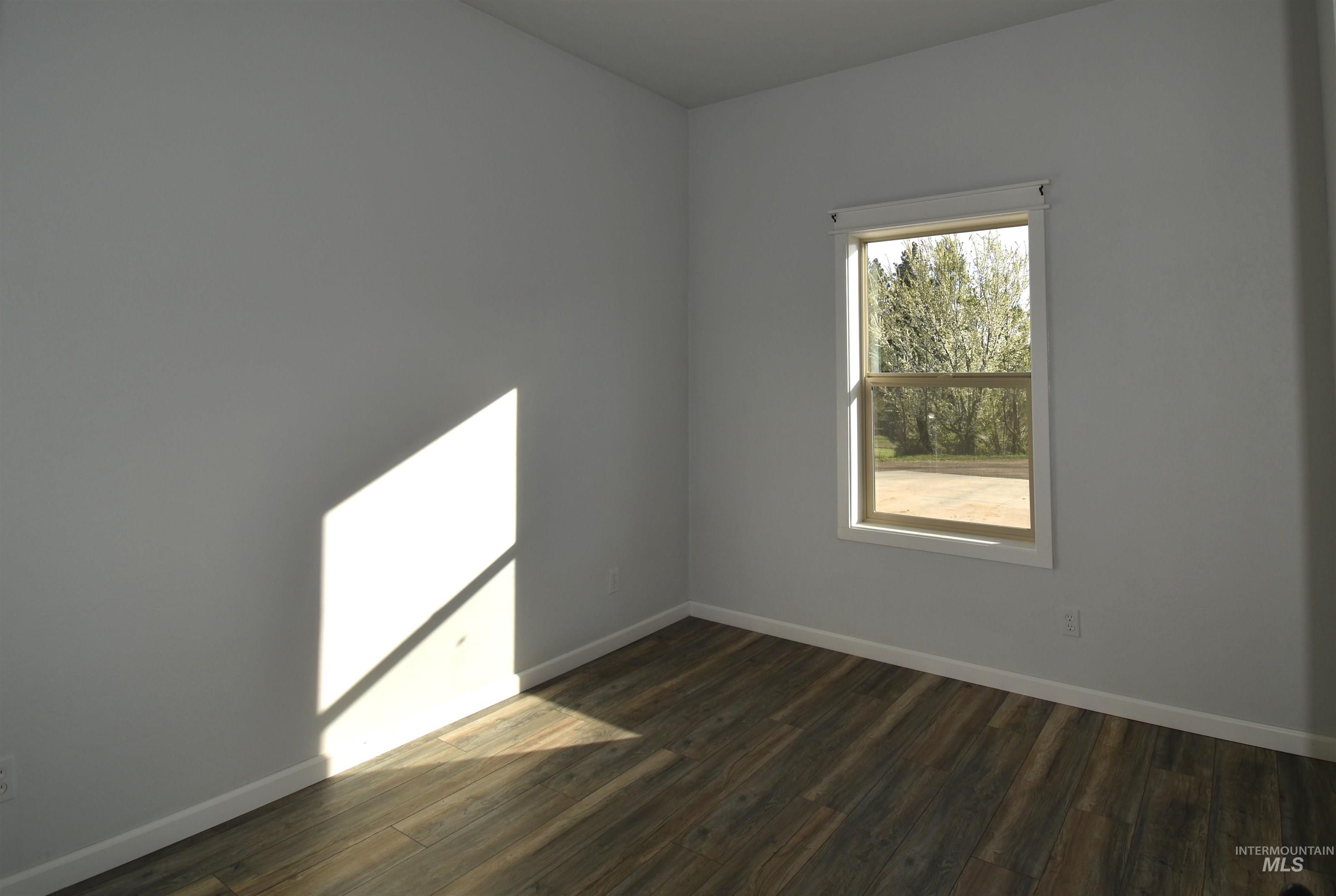2599 Fruitvale Glendale Road Council, ID 83612 - Photo 27 of 29 Spare room featuring dark wood-style flooring