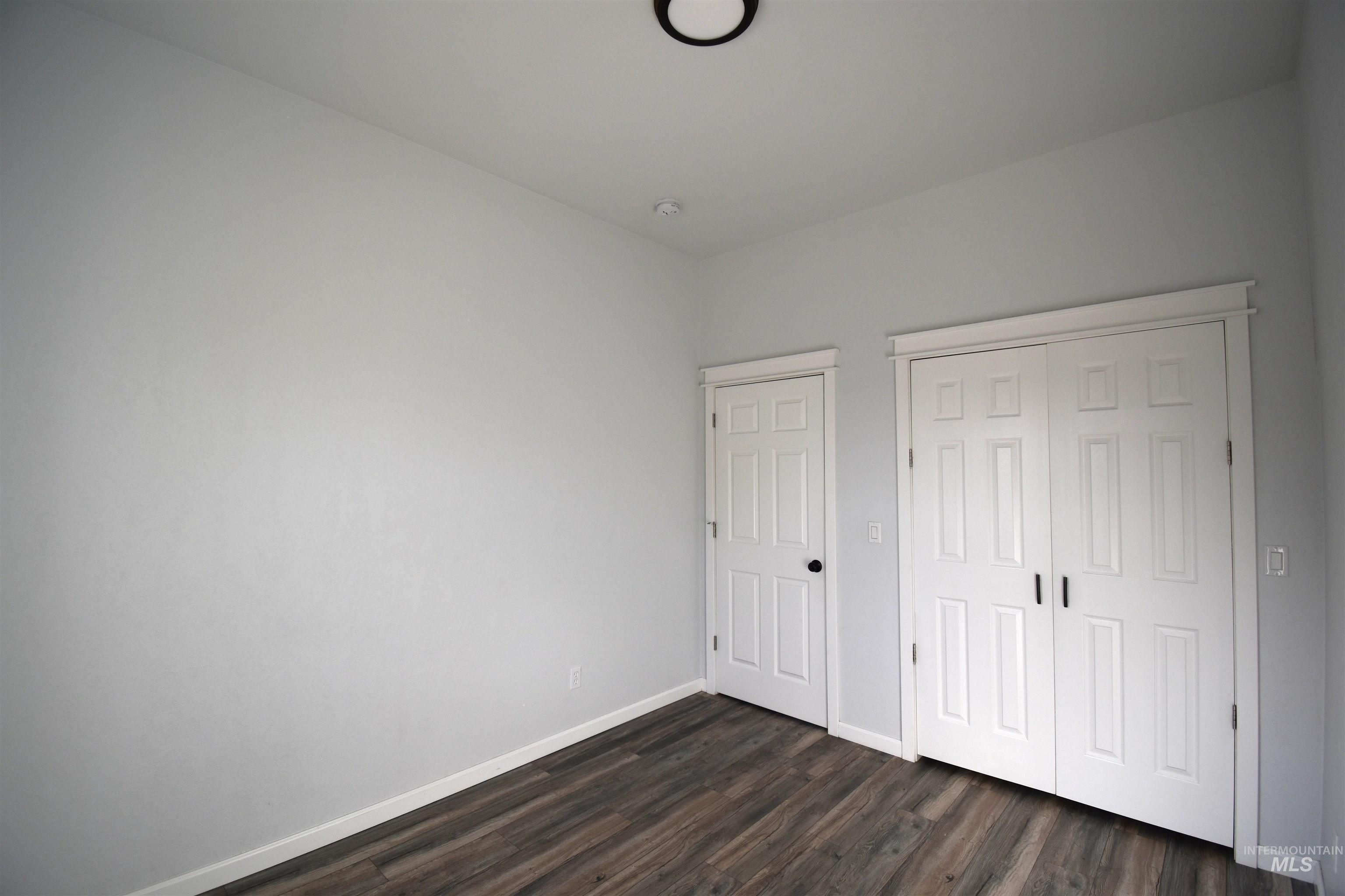 2599 Fruitvale Glendale Road Council, ID 83612 - Photo 28 of 29 Unfurnished bedroom featuring dark wood finished floors and a closet