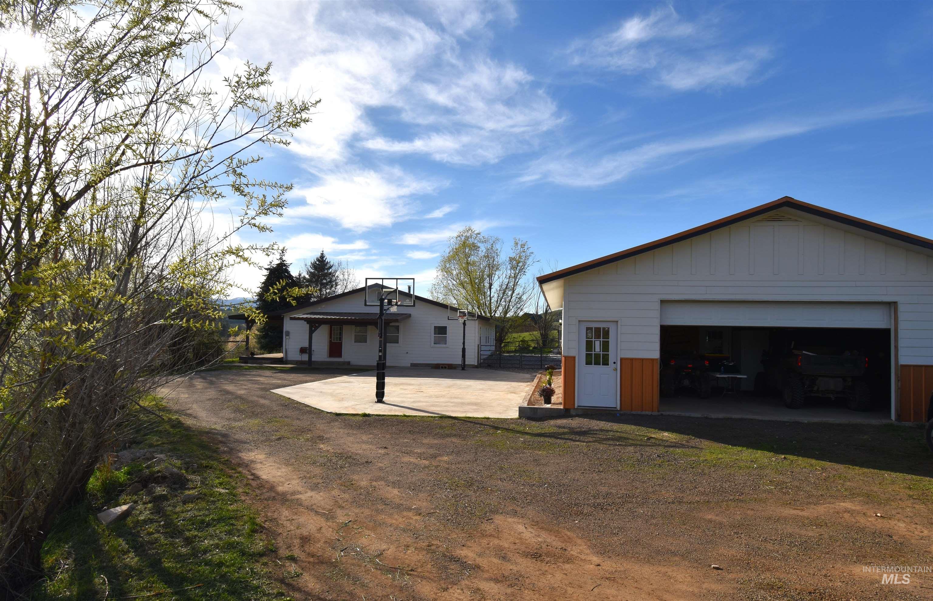 2599 Fruitvale Glendale Road Council, ID 83612 - Photo 10 of 29 View of home's exterior featuring an outbuilding, a garage, and board and batten siding
