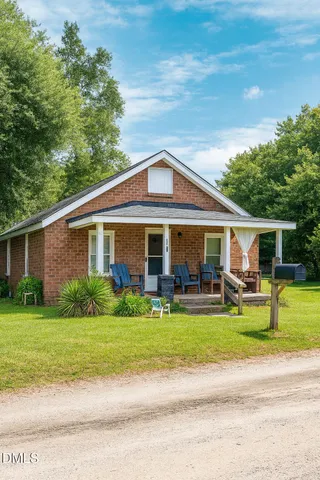 a front view of house with yard porch and green space