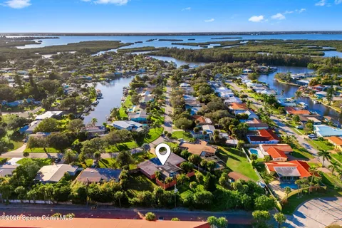 an aerial view of a houses with a lake view