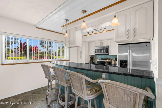 a view of a dining room with furniture wooden floor and window