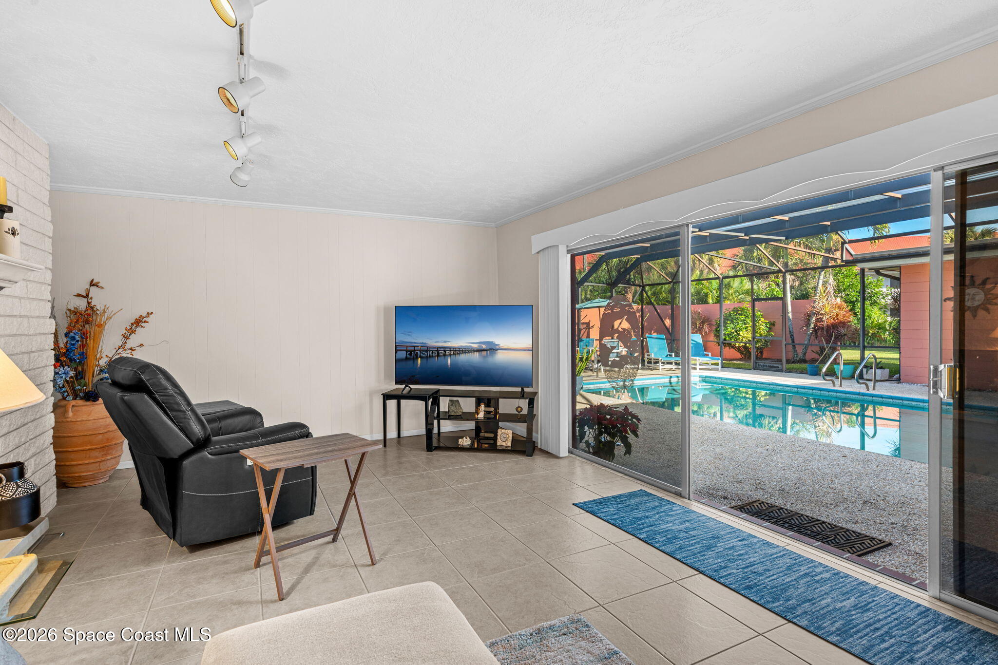 1044 Samar Road Cocoa Beach, FL 32931 - Photo 17 of 56 a living room with furniture and a floor to ceiling window