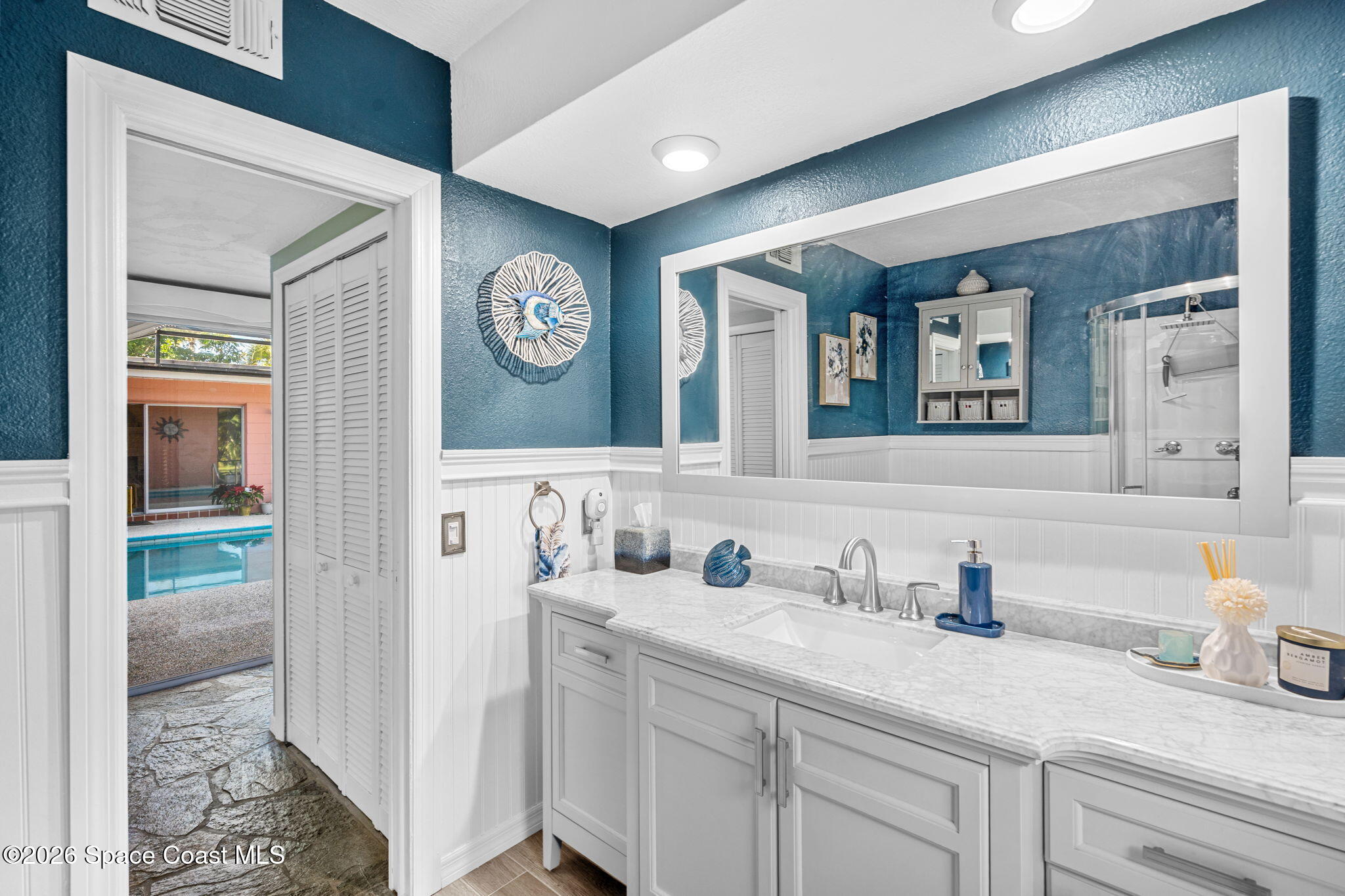 1044 Samar Road Cocoa Beach, FL 32931 - Photo 2 of 56 a bathroom with a sink and a mirror