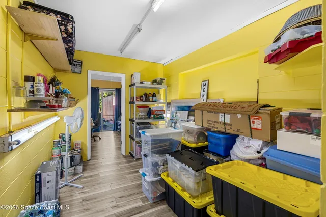 a room with furniture a rug toys and a window