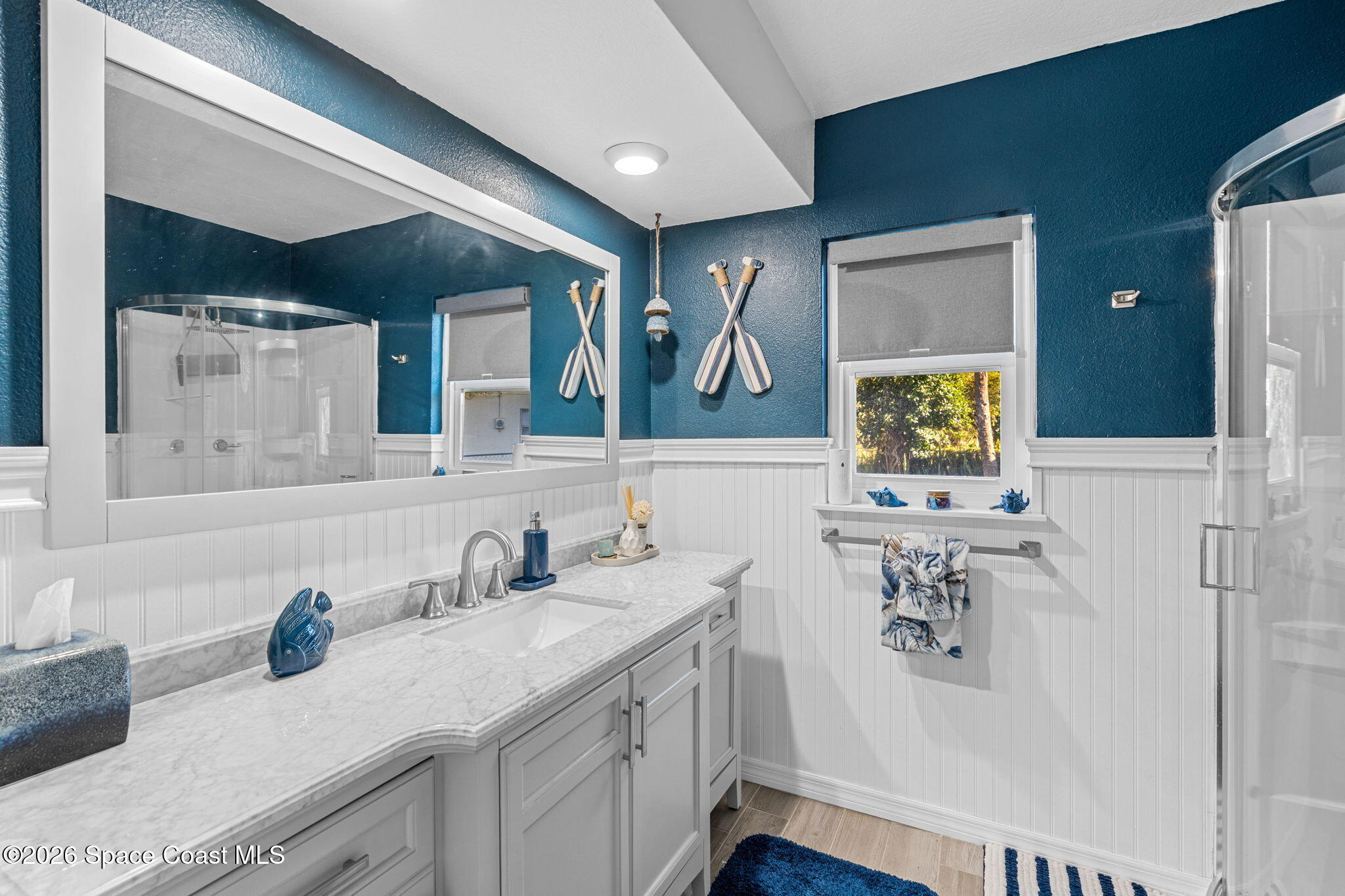 1044 Samar Road Cocoa Beach, FL 32931 - Photo 28 of 56 a bathroom with a sink mirror and vanity