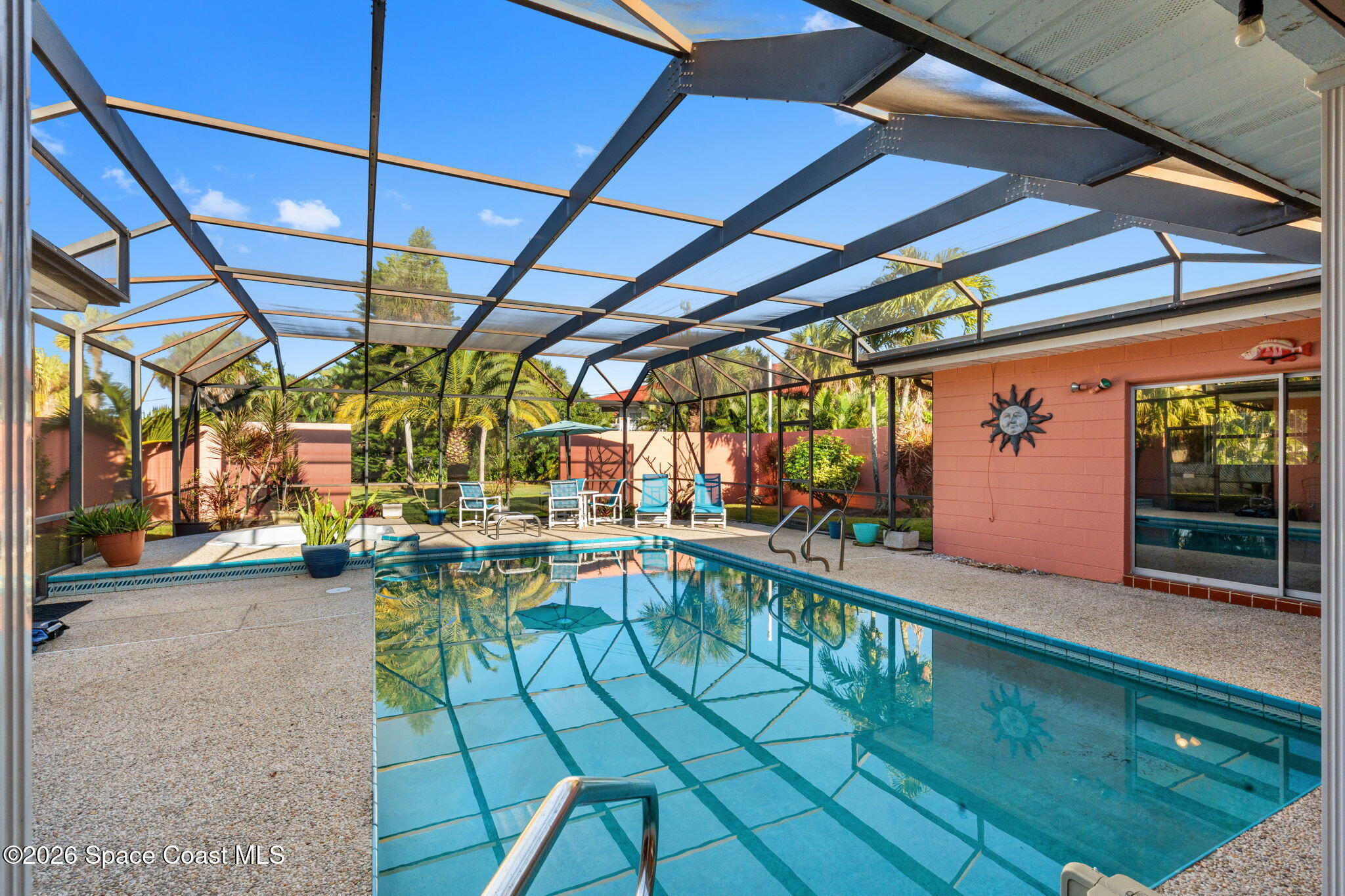 1044 Samar Road Cocoa Beach, FL 32931 - Photo 42 of 56 a view of a swimming pool with a patio