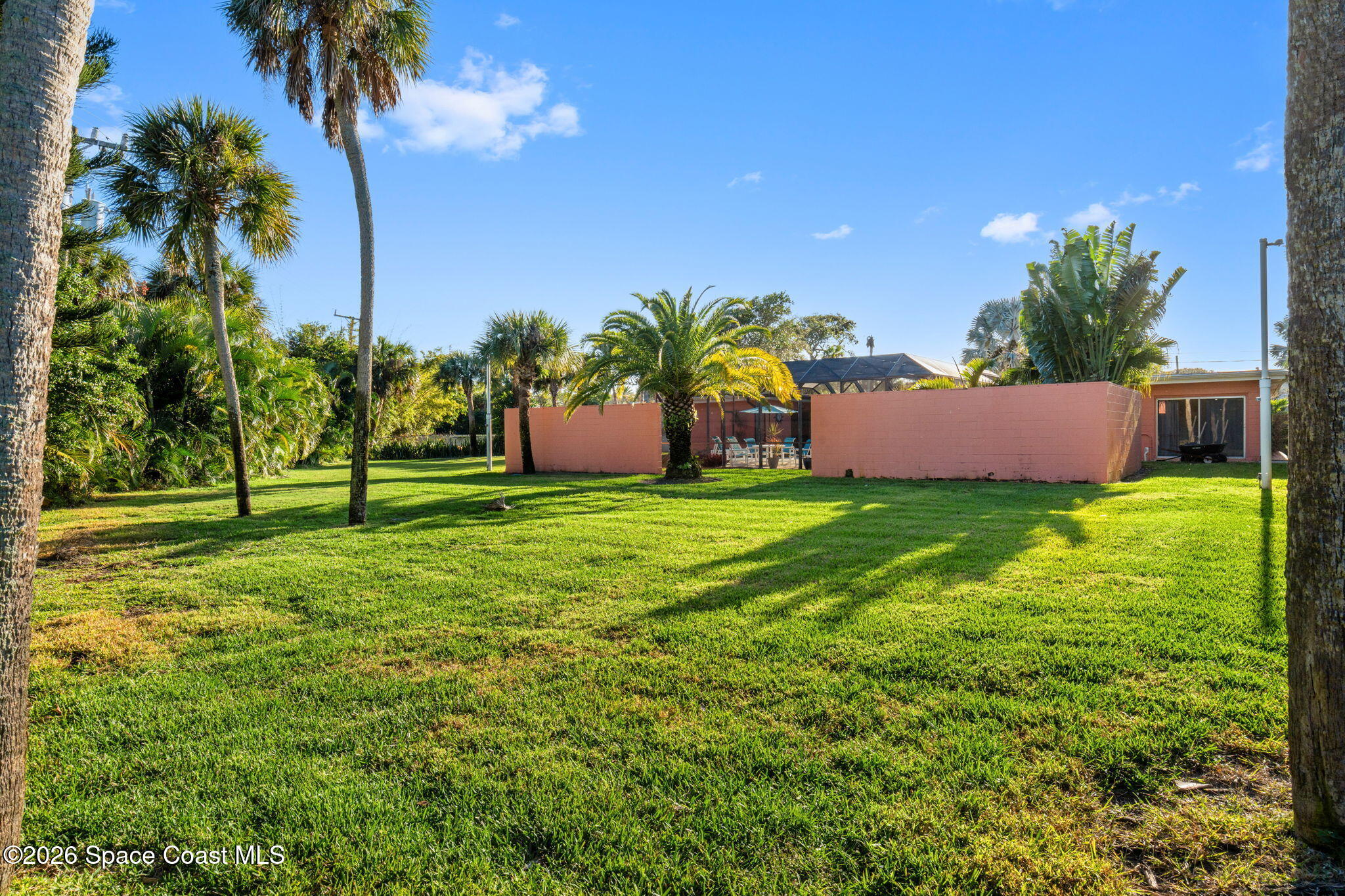 1044 Samar Road Cocoa Beach, FL 32931 - Photo 49 of 56 a view of a house with a yard and a fountain