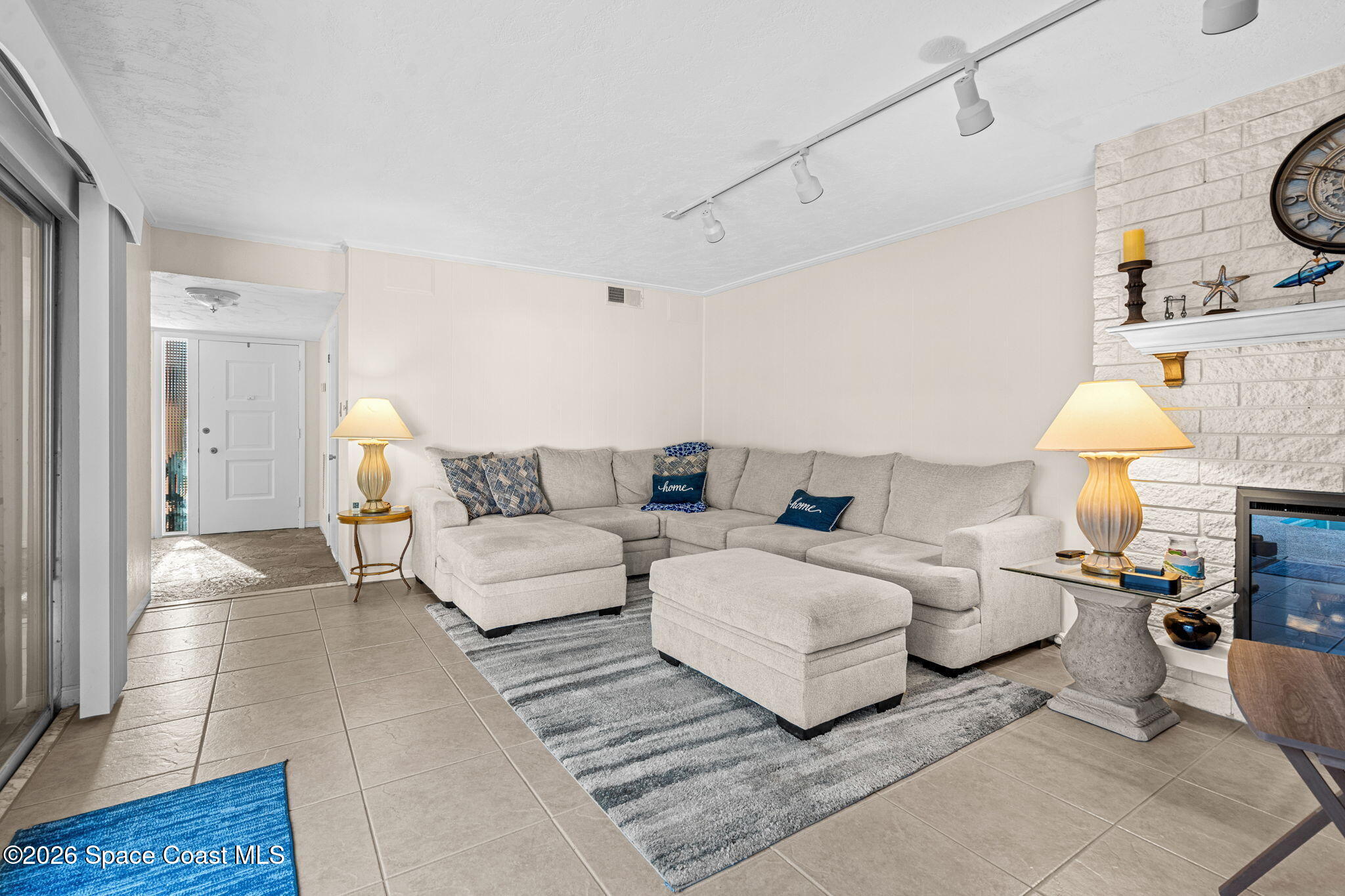 1044 Samar Road Cocoa Beach, FL 32931 - Photo 10 of 56 a living room with furniture and a lamp