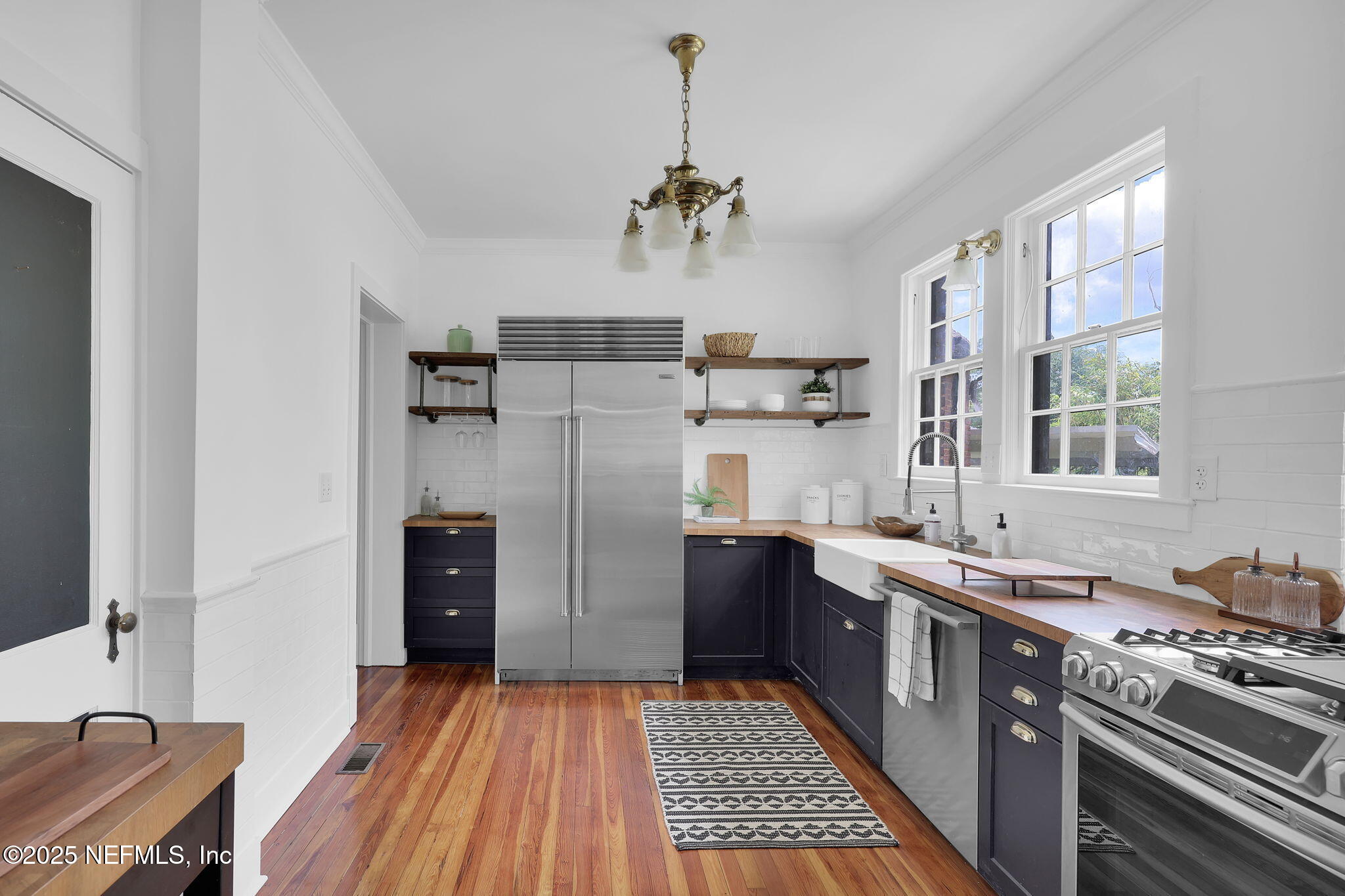 1475 Edgewood Circle Jacksonville, FL 32205 - Photo 17 of 60 a kitchen with stainless steel appliances granite countertop a refrigerator a sink dishwasher a stove and white countertops with wooden floor