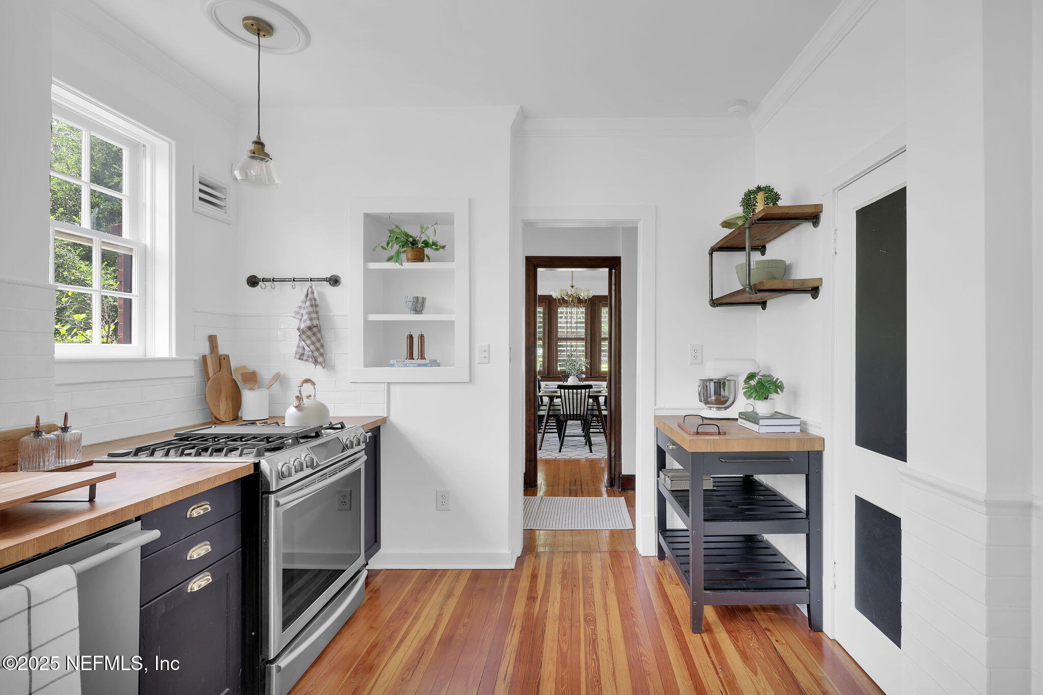 1475 Edgewood Circle Jacksonville, FL 32205 - Photo 18 of 60 a kitchen that has a lot of cabinets stainless steel appliances and a window