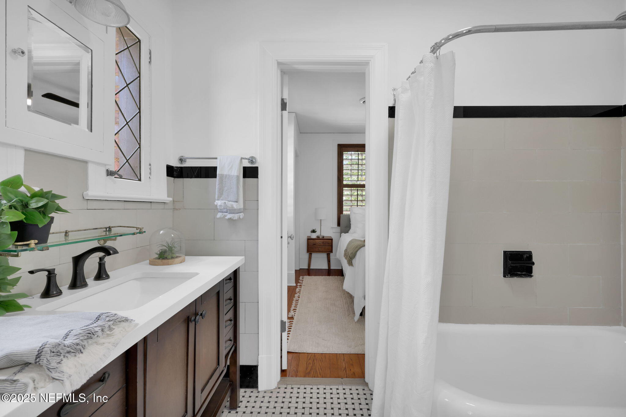 1475 Edgewood Circle Jacksonville, FL 32205 - Photo 36 of 60 a en suite bathroom with a sink a mirror and a shower