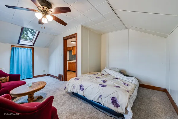 a bedroom with a bed and ceiling fan