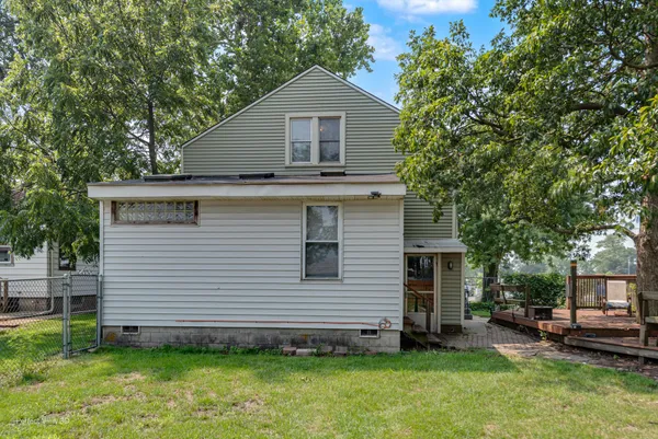 a view of a house with a yard and sitting area