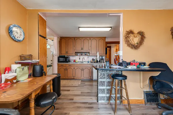 a kitchen with a table chairs stove and cabinets