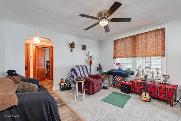 a living room with furniture fireplace and a large window