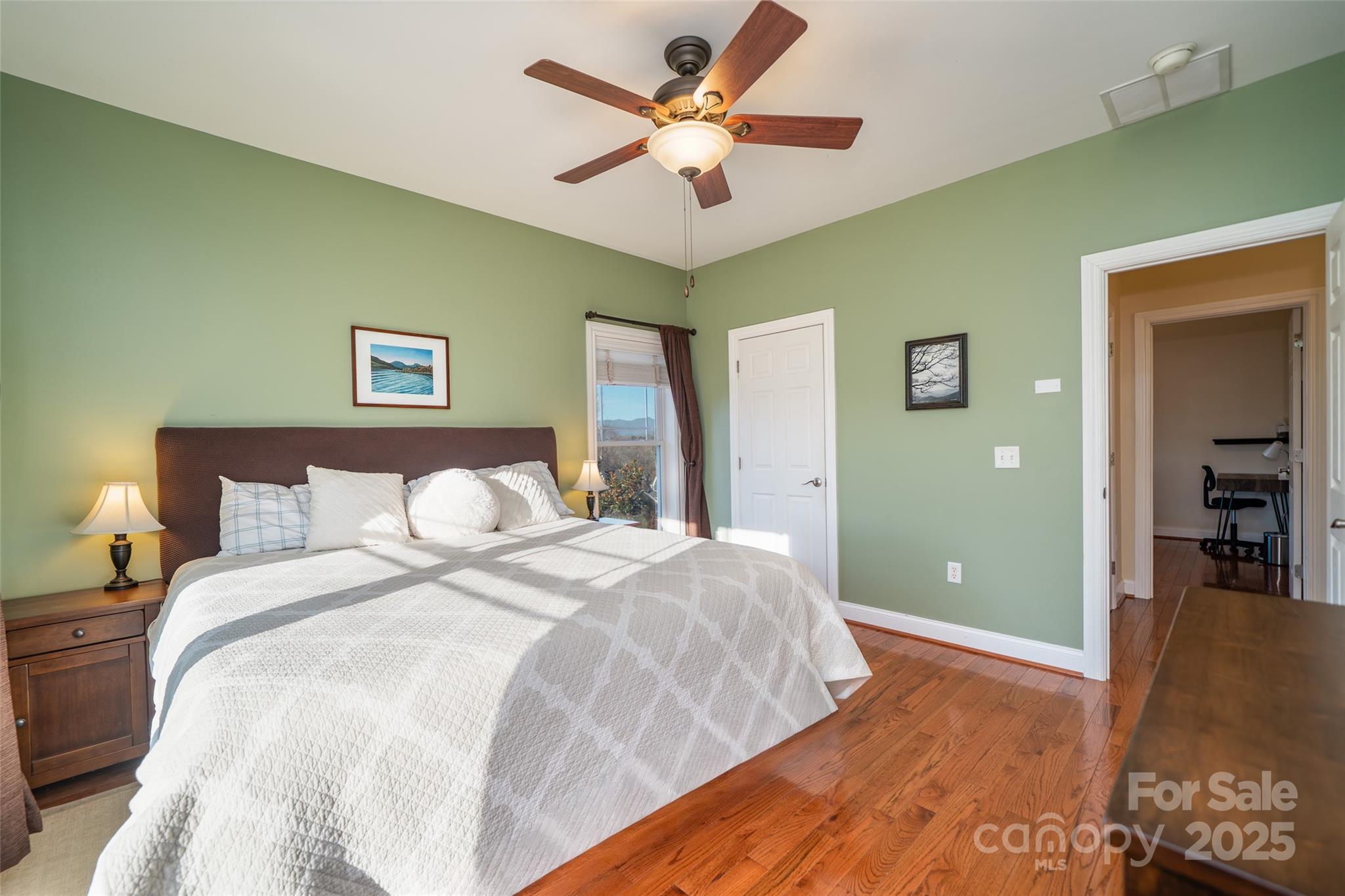 11 Forest Park Lane Asheville, NC 28803 - Photo 11 of 26 a bedroom with a bed and a chandelier