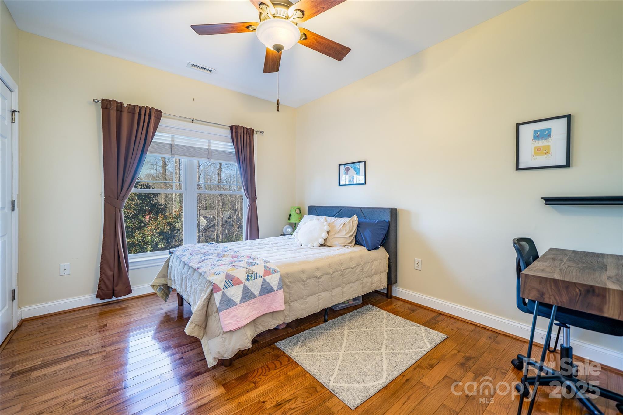11 Forest Park Lane Asheville, NC 28803 - Photo 13 of 26 a bedroom with a bed a chair and a potted plant