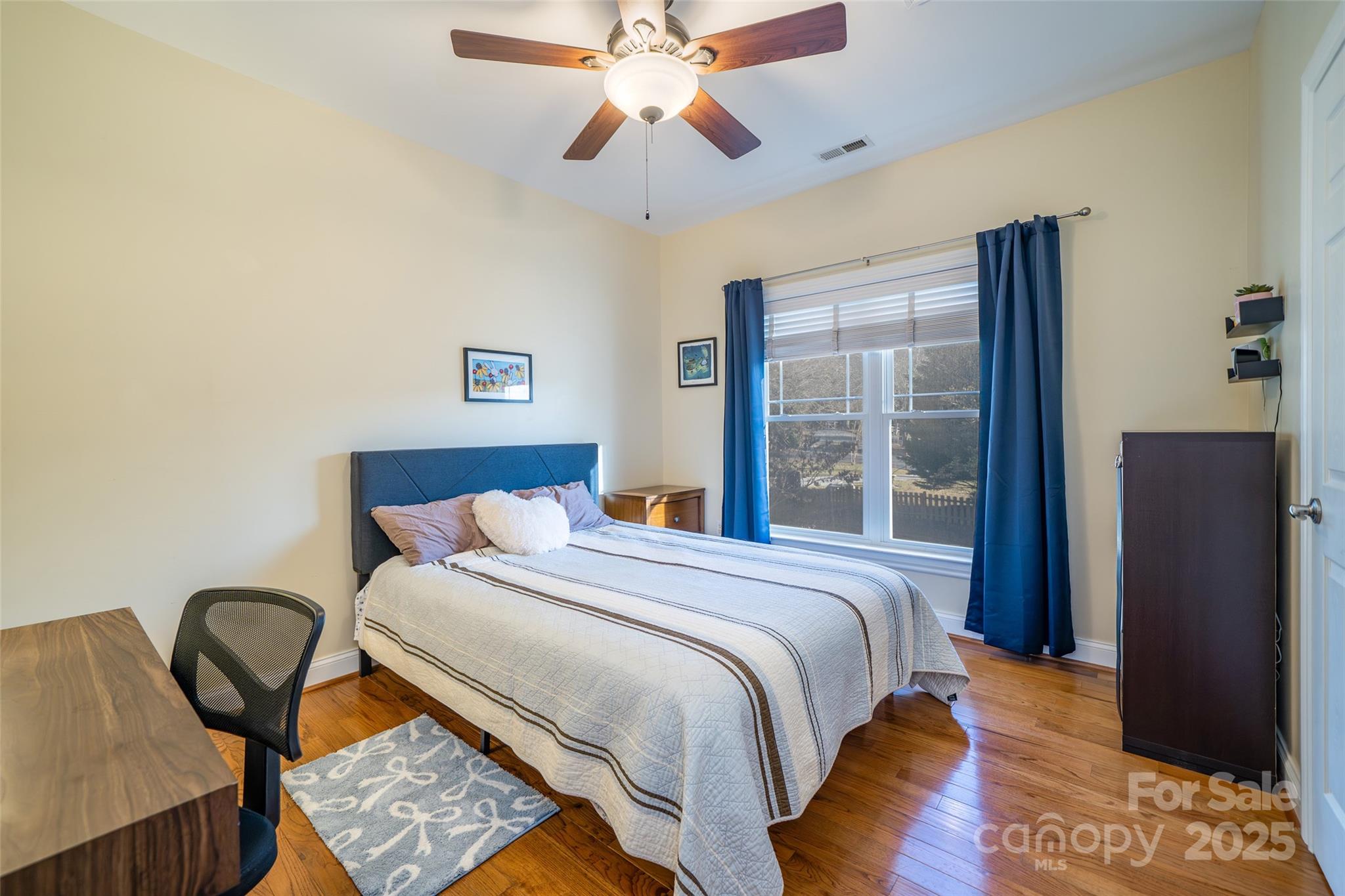 11 Forest Park Lane Asheville, NC 28803 - Photo 14 of 26 a bedroom with a bed and a chandelier