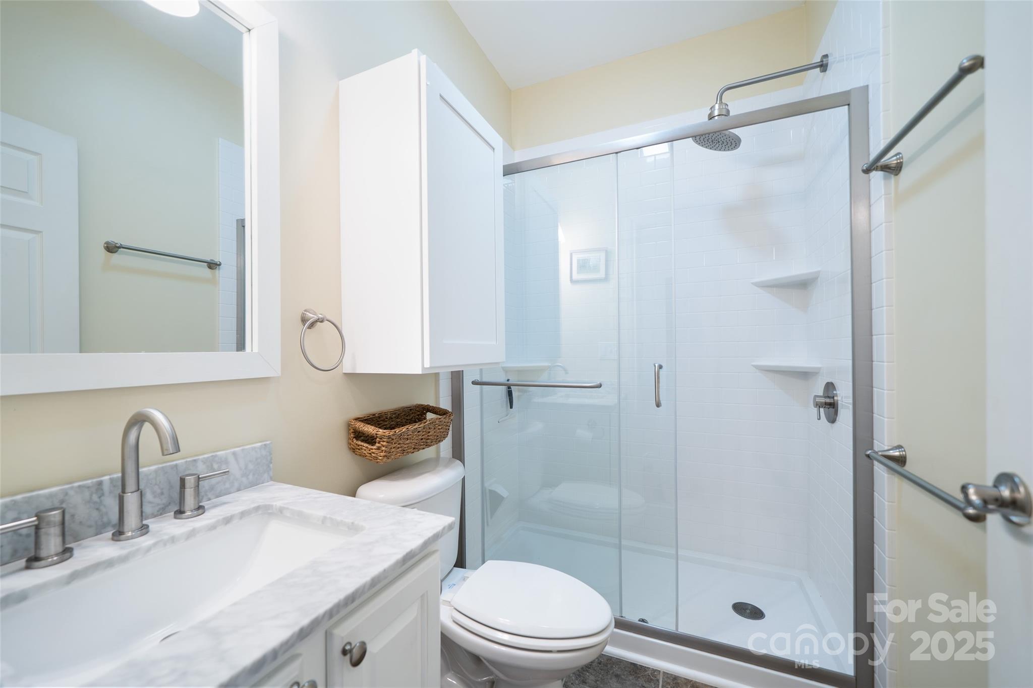 11 Forest Park Lane Asheville, NC 28803 - Photo 15 of 26 a bathroom with a sink a toilet and shower