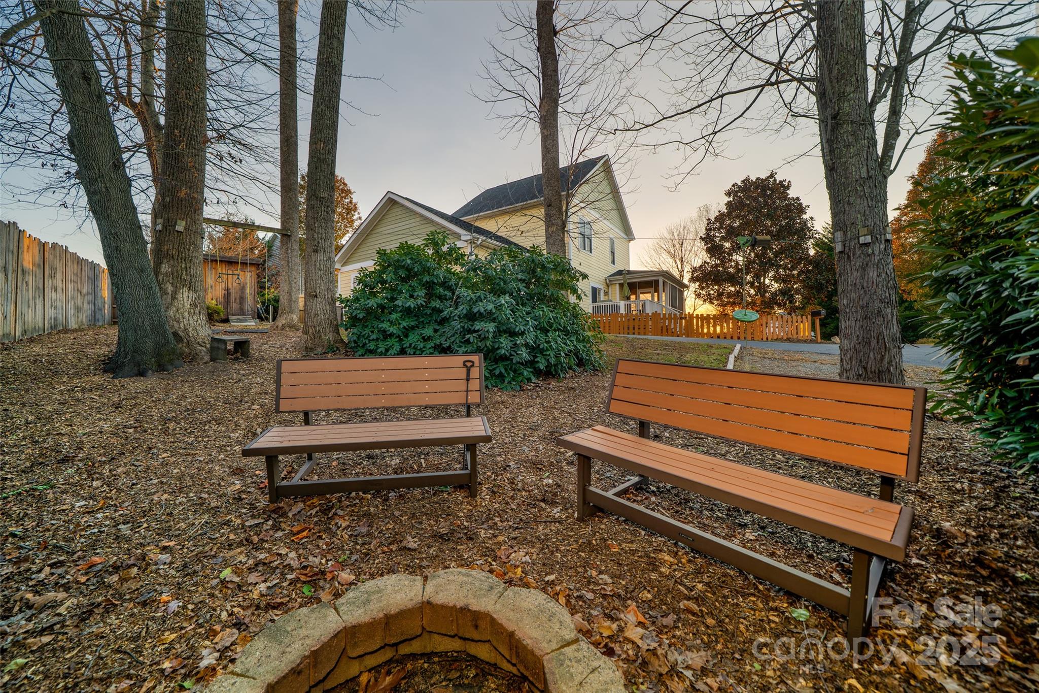 11 Forest Park Lane Asheville, NC 28803 - Photo 21 of 26 a view of a bench in a backyard