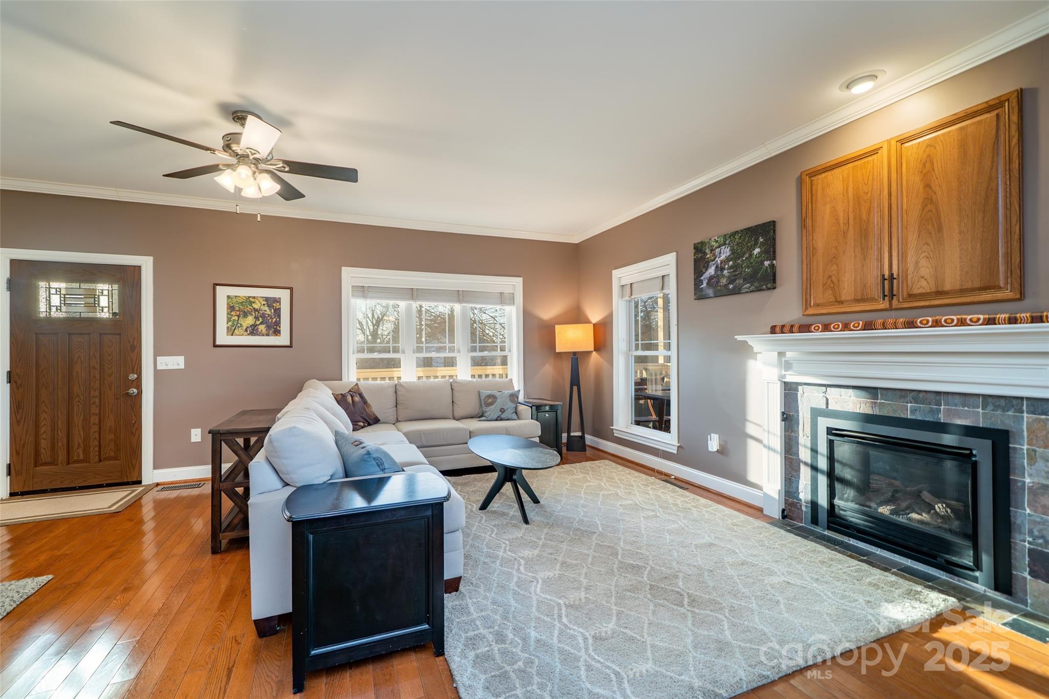 11 Forest Park Lane Asheville, NC 28803 - Photo 6 of 26 a living room with furniture a window and a fireplace