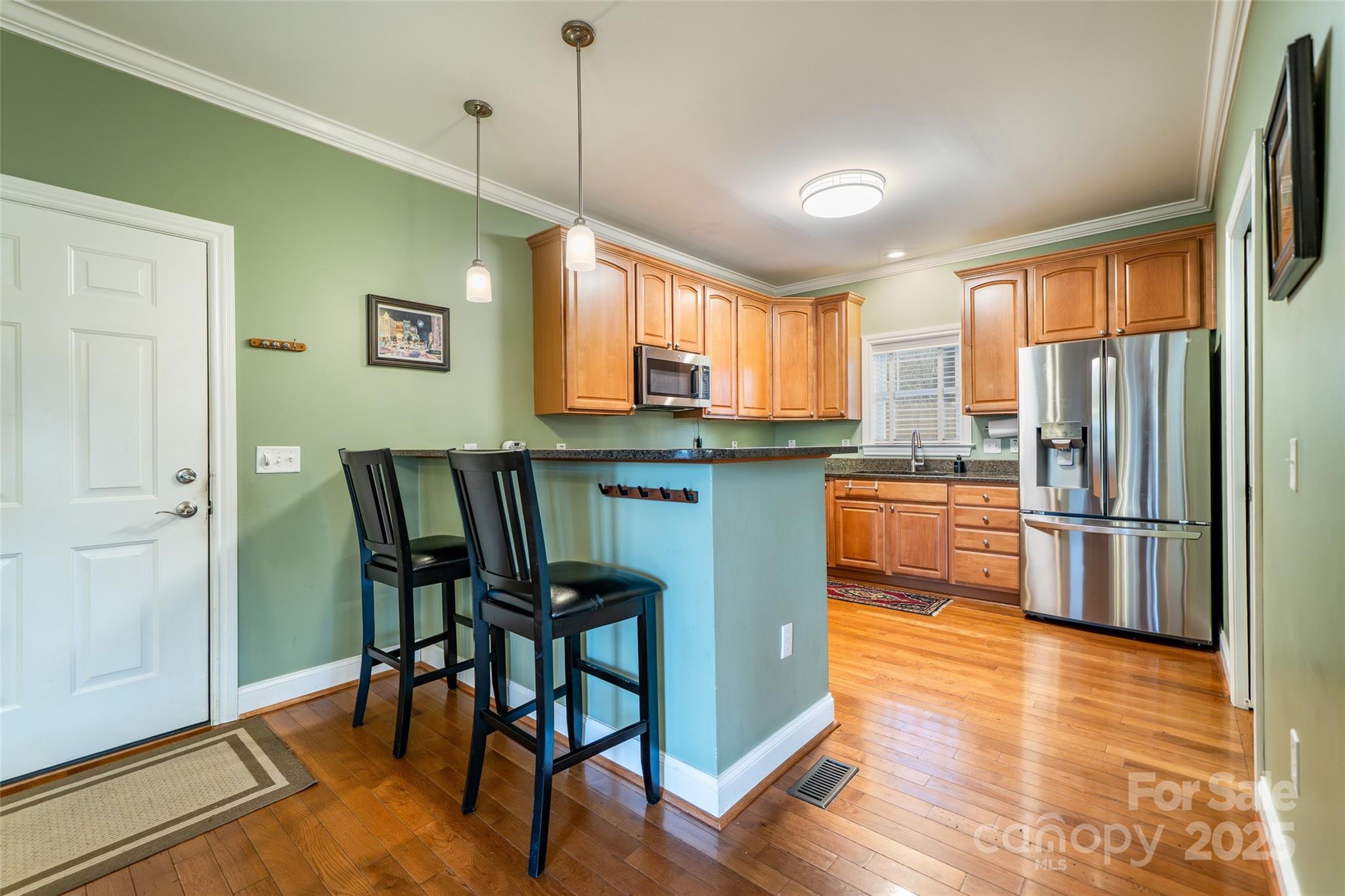 11 Forest Park Lane Asheville, NC 28803 - Photo 8 of 26 a kitchen with stainless steel appliances granite countertop a table chairs refrigerator and a window