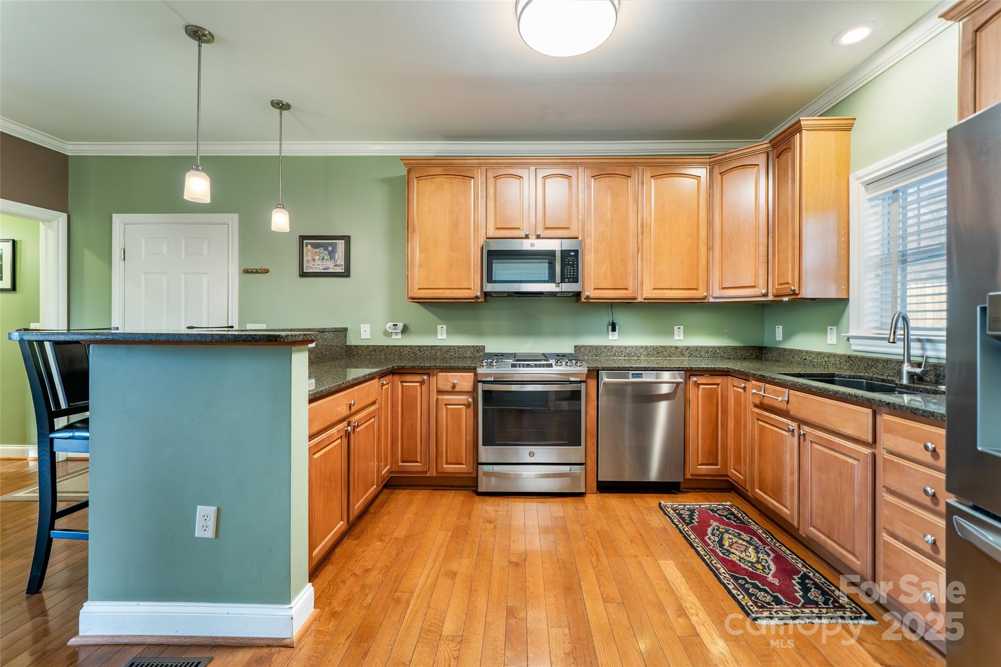 11 Forest Park Lane Asheville, NC 28803 - Photo 9 of 26 a kitchen with stainless steel appliances granite countertop a stove a sink and a microwave