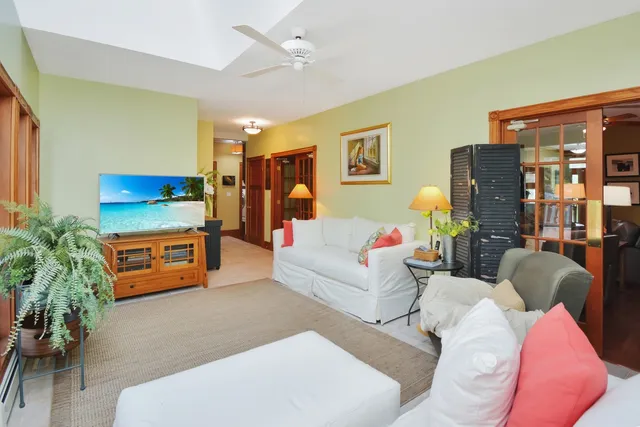 a living room with furniture a fireplace and a window