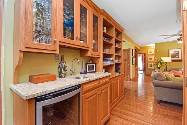a living room with furniture and a fireplace with wooden floor