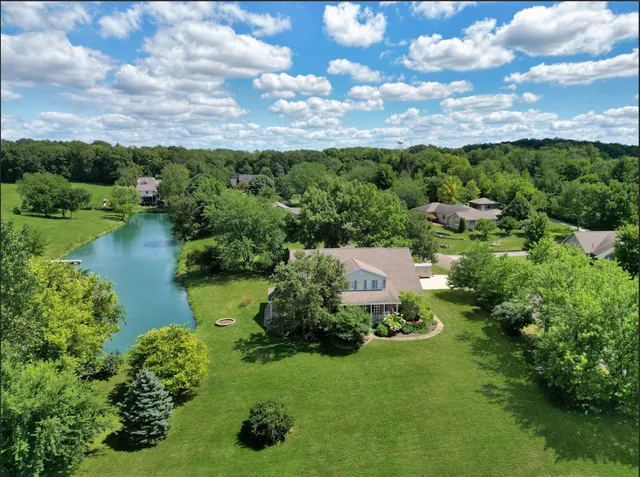 a dining table chairs and a refrigerator in a kitchen