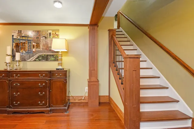an aerial view of a house with a garden and lake view