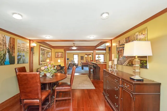 a view of a entryway door with hallway and wooden floor