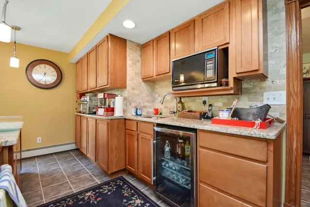 a kitchen with stainless steel appliances granite countertop a stove and a refrigerator