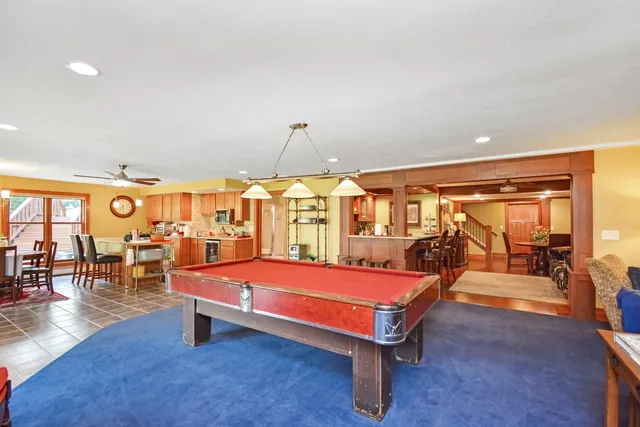 a spacious bedroom with a bed and dresser with mirror