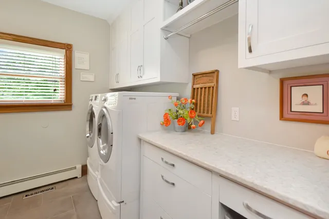 a living room with furniture stairs and a ceiling fan