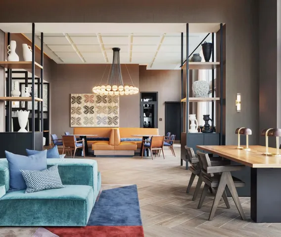 a living room with furniture a chandelier and a dining table