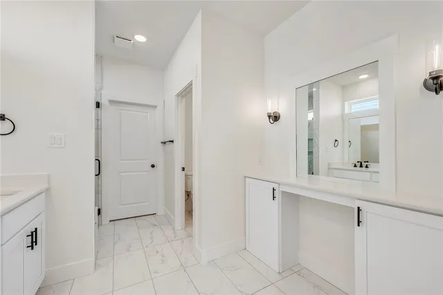 a bathroom with a double vanity sink mirror and