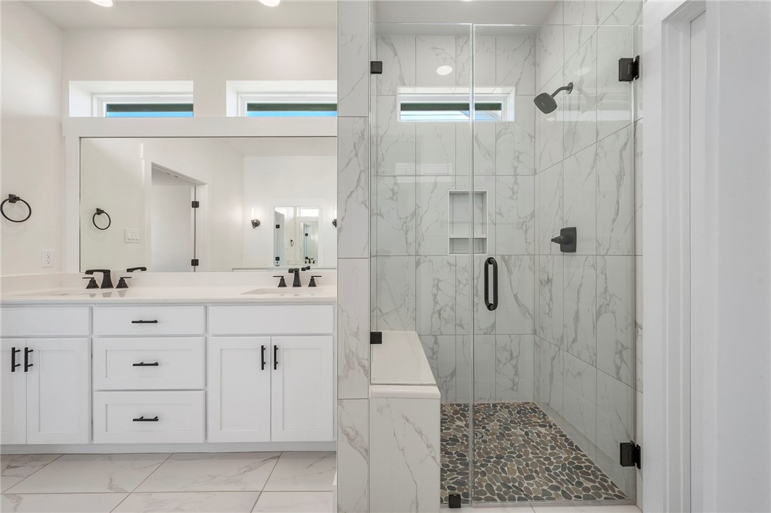 569 Harvest Lk Drive Snook, TX 77879 - Photo 13 of 22 Full bath with a marble finish shower, double vanity, light marble finish floors, and recessed lighting