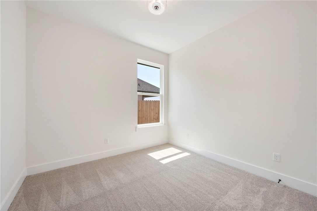 569 Harvest Lk Drive Snook, TX 77879 - Photo 16 of 22 Empty room featuring carpet and baseboards