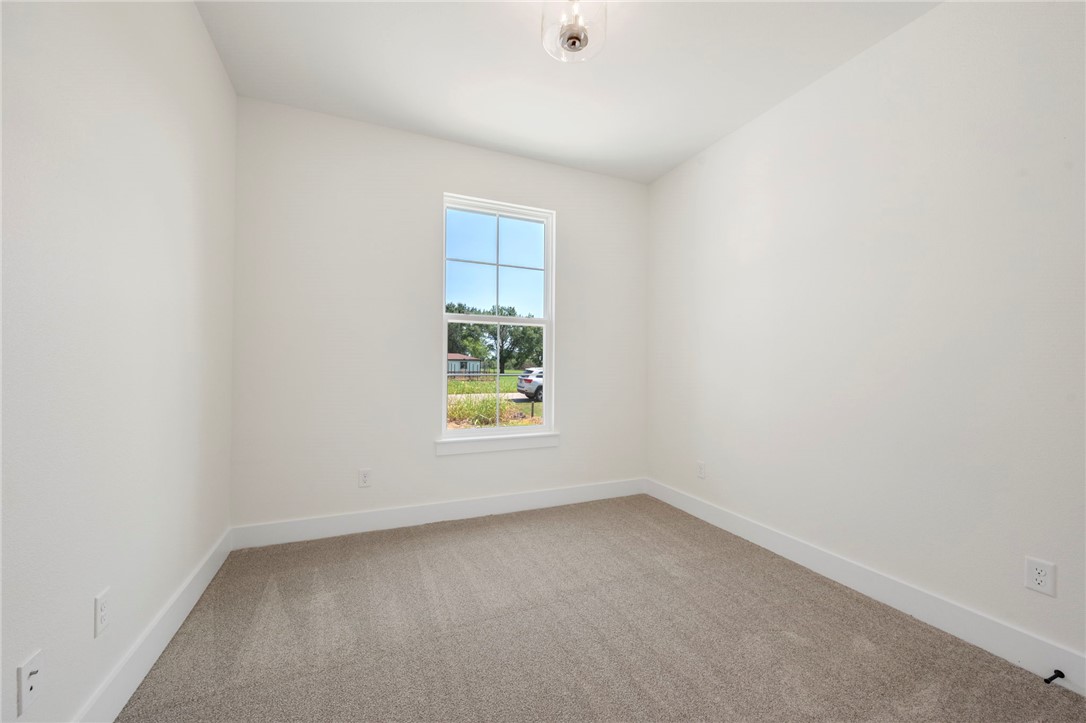 569 Harvest Lk Drive Snook, TX 77879 - Photo 17 of 22 Empty room with carpet floors and baseboards