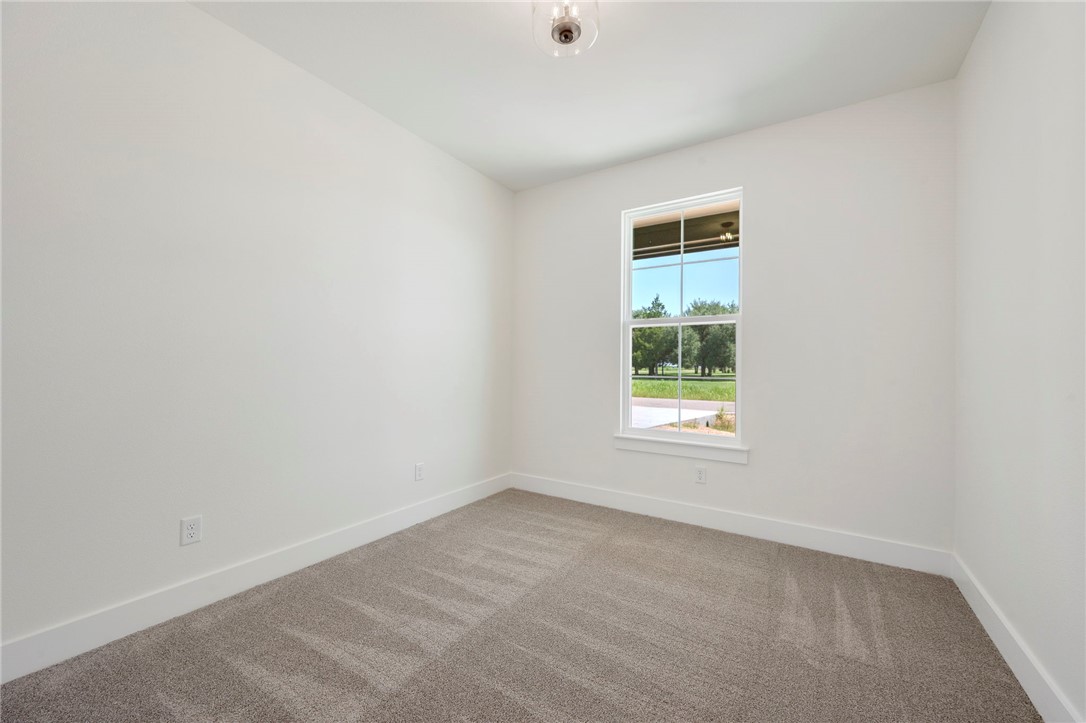 569 Harvest Lk Drive Snook, TX 77879 - Photo 19 of 22 Spare room with light colored carpet and baseboards