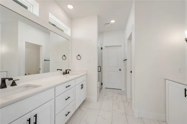 a spacious bathroom with a double vanity sink mirror and