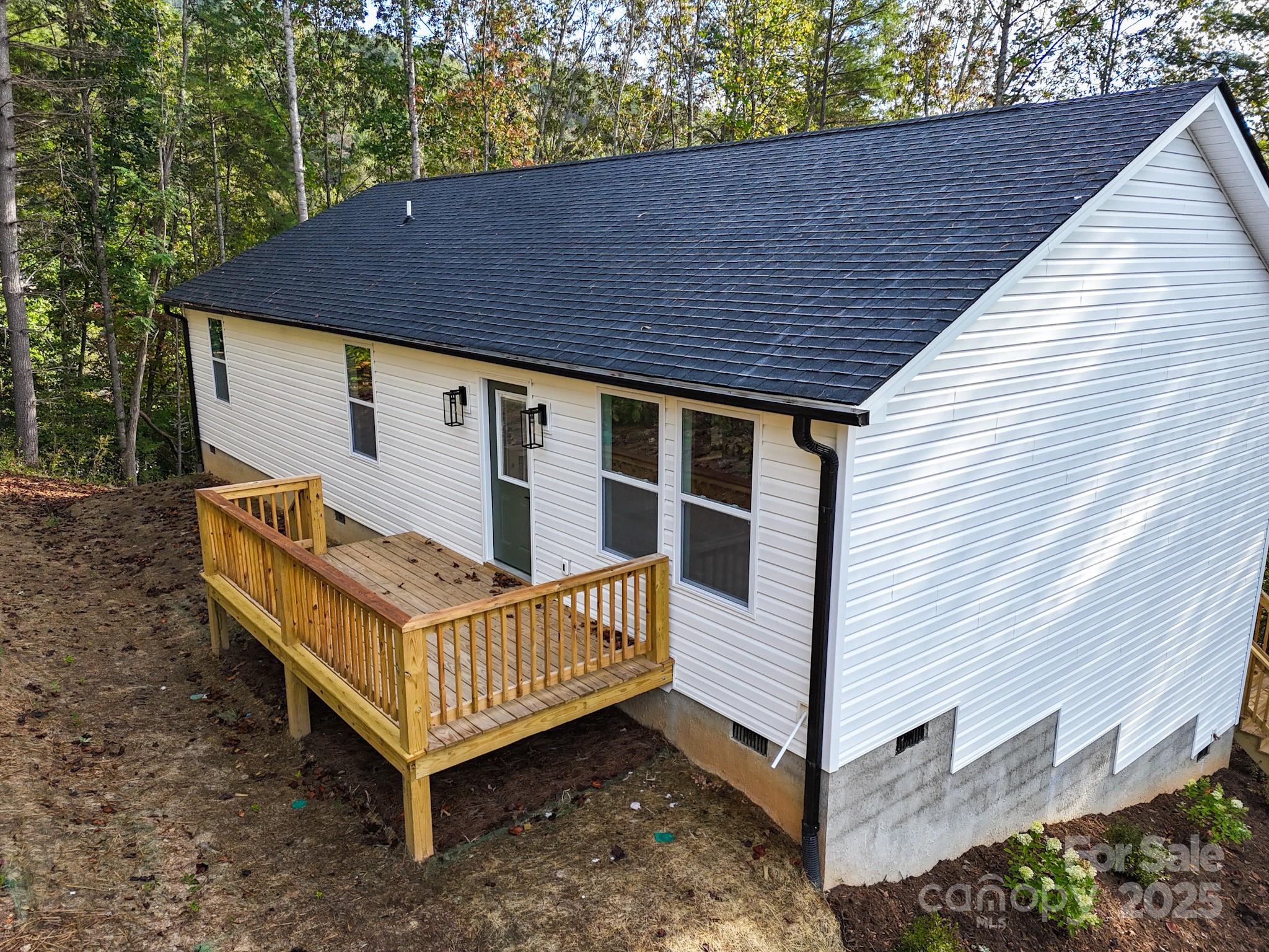 700 Old Fort Road Fairview, NC 28730 - Photo 39 of 42 a view of a house with a yard and deck area under a large tree