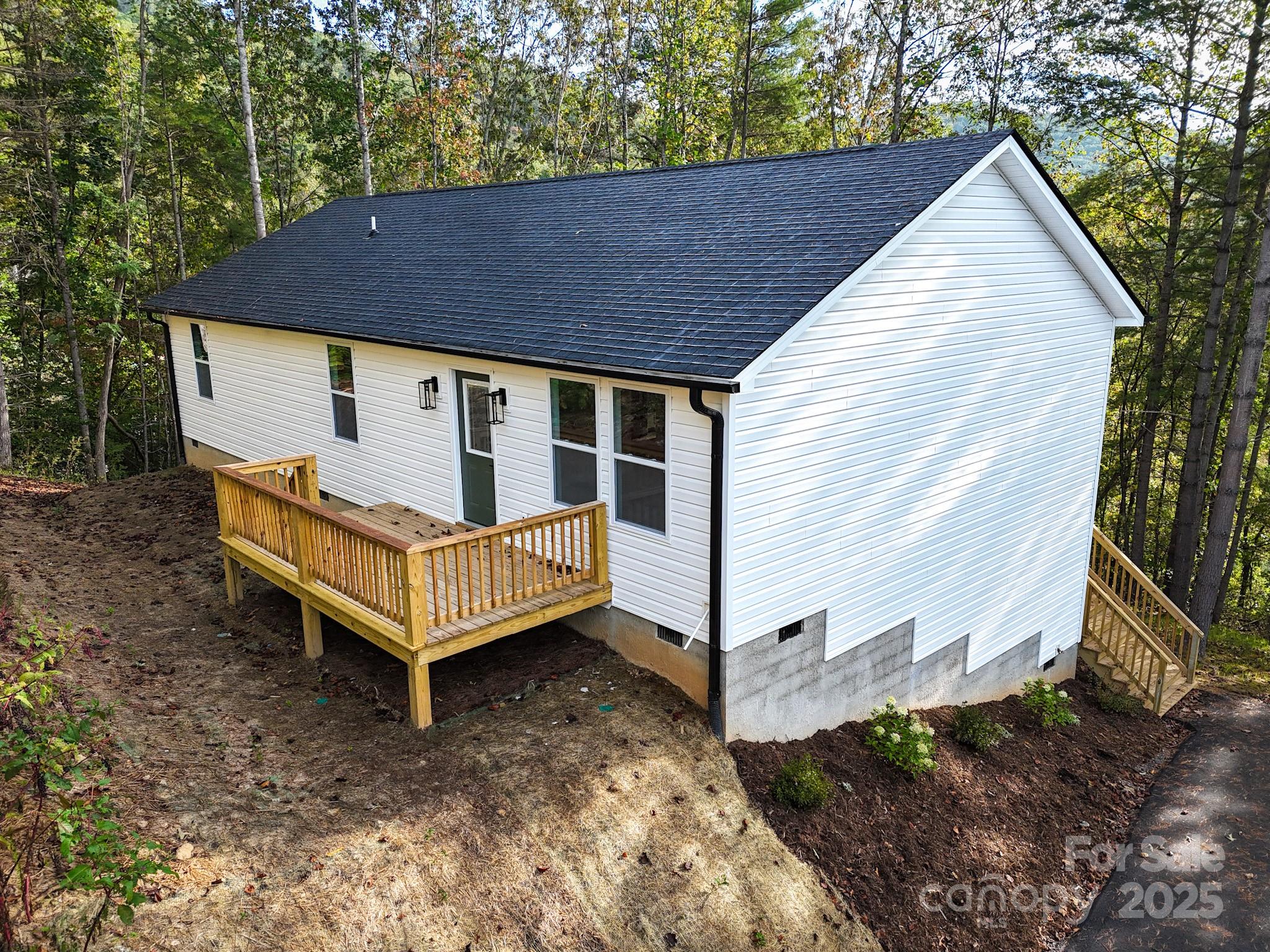 700 Old Fort Road Fairview, NC 28730 - Photo 6 of 42 a view of a white house with a yard and wooden roof