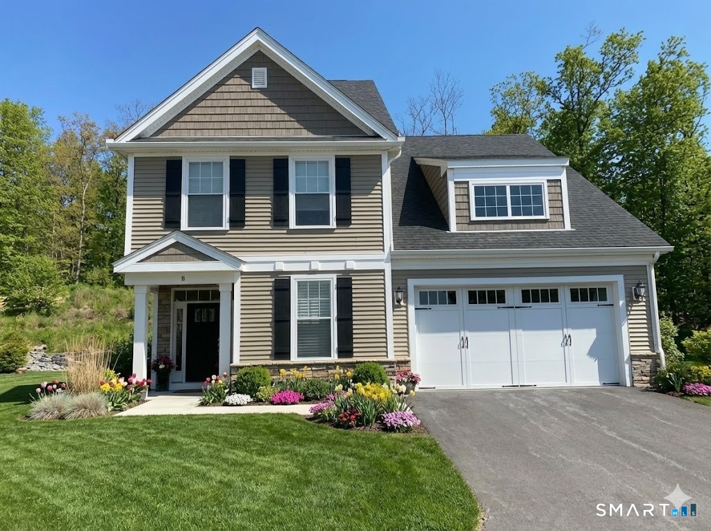 8 Woodland Path, Unit 8 Beacon Falls, CT 06403 - Photo 1 of 1 a front view of a house with a yard and garage