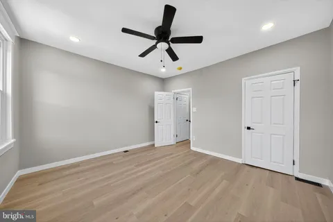 a view of room with ceiling fan and wooden floor