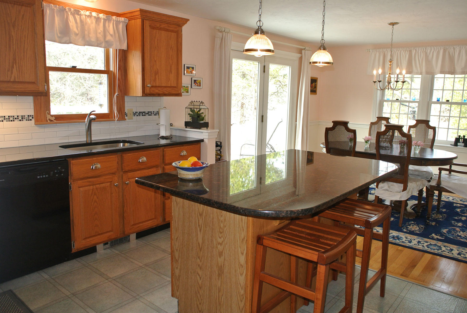 32 Wintergreen Road Mashpee, MA 02649 - Photo 3 of 19 a kitchen with stainless steel appliances granite countertop a sink a stove and chairs