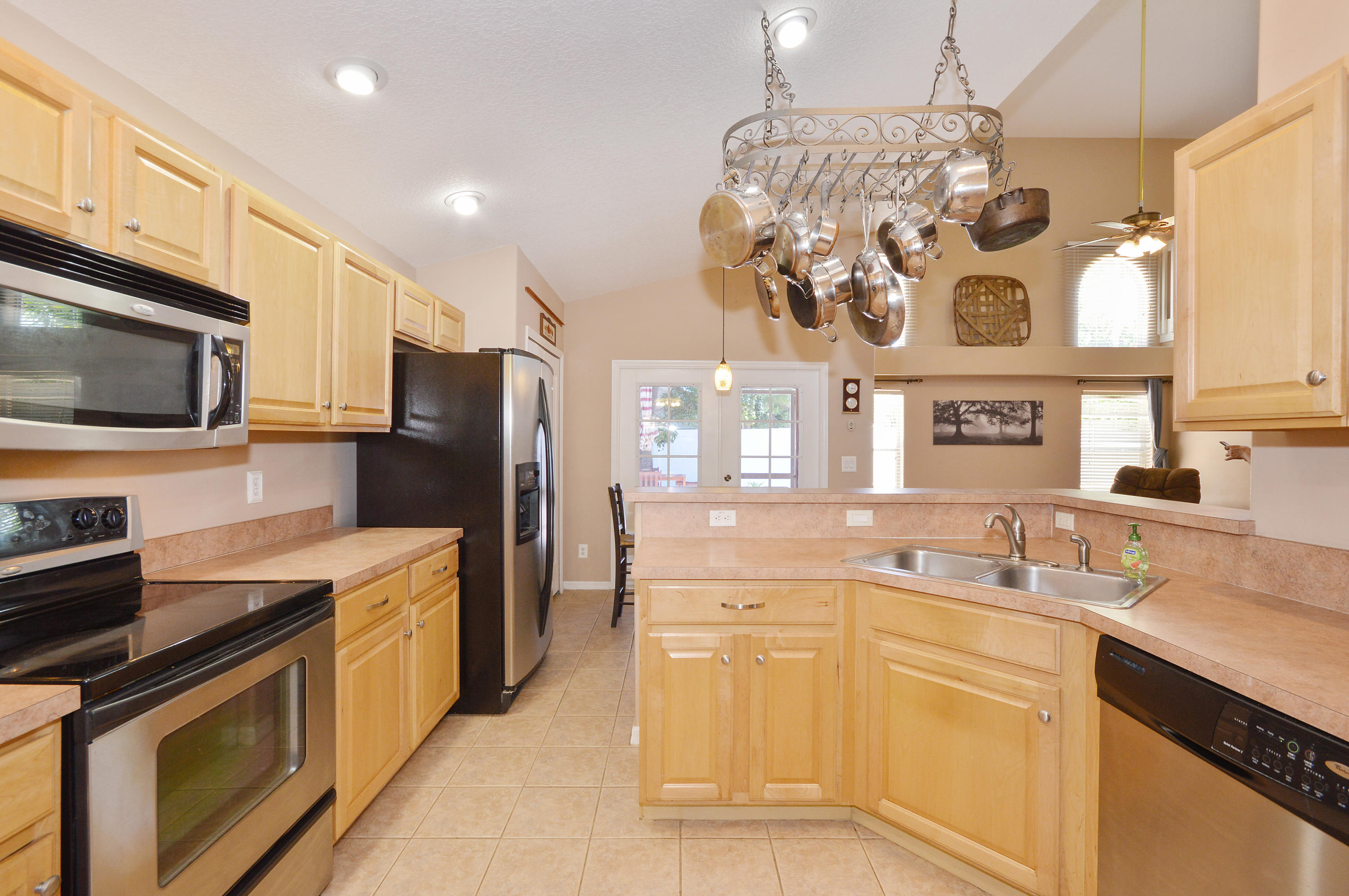 1132 Canoe Point Delray Beach, FL 33444 - Photo 3 of 16 a kitchen with stainless steel appliances granite countertop a sink and cabinets