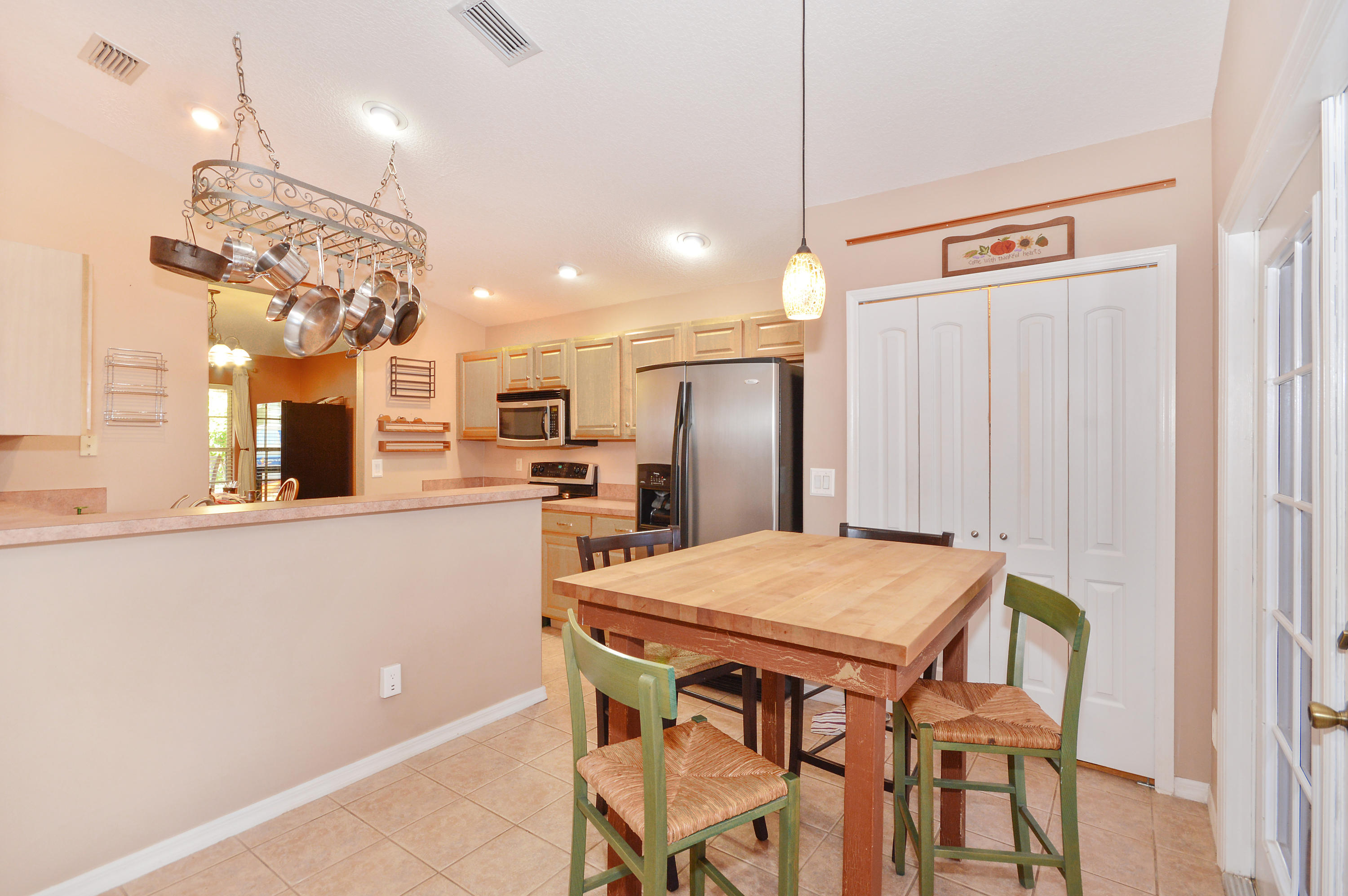 1132 Canoe Point Delray Beach, FL 33444 - Photo 4 of 16 a kitchen with a table and chairs in it